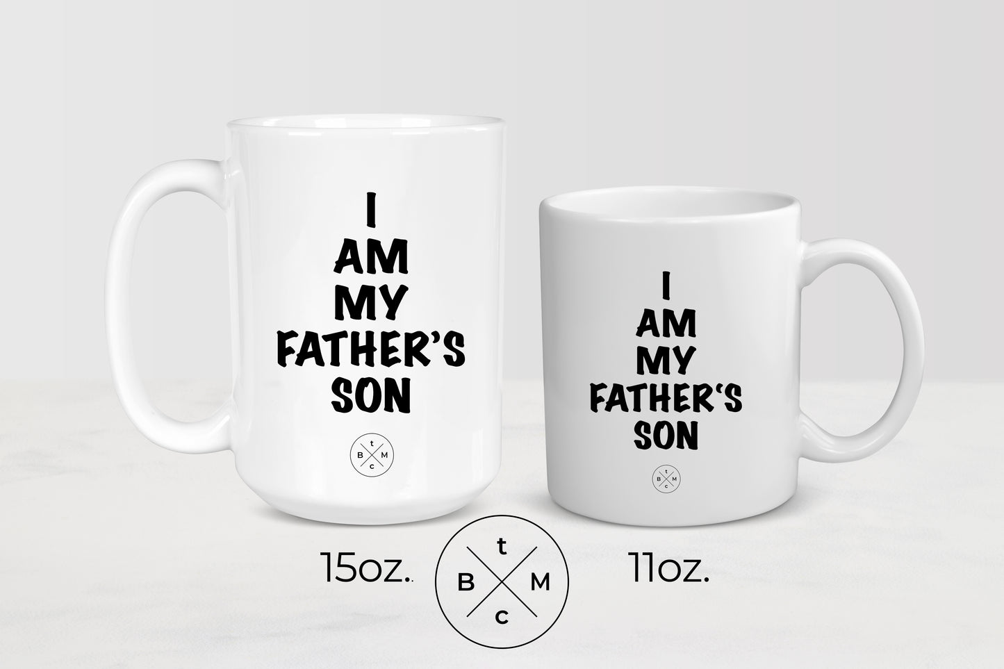 11 ounce and 15 ounce white ceramic mugs with black text I am my father’s son