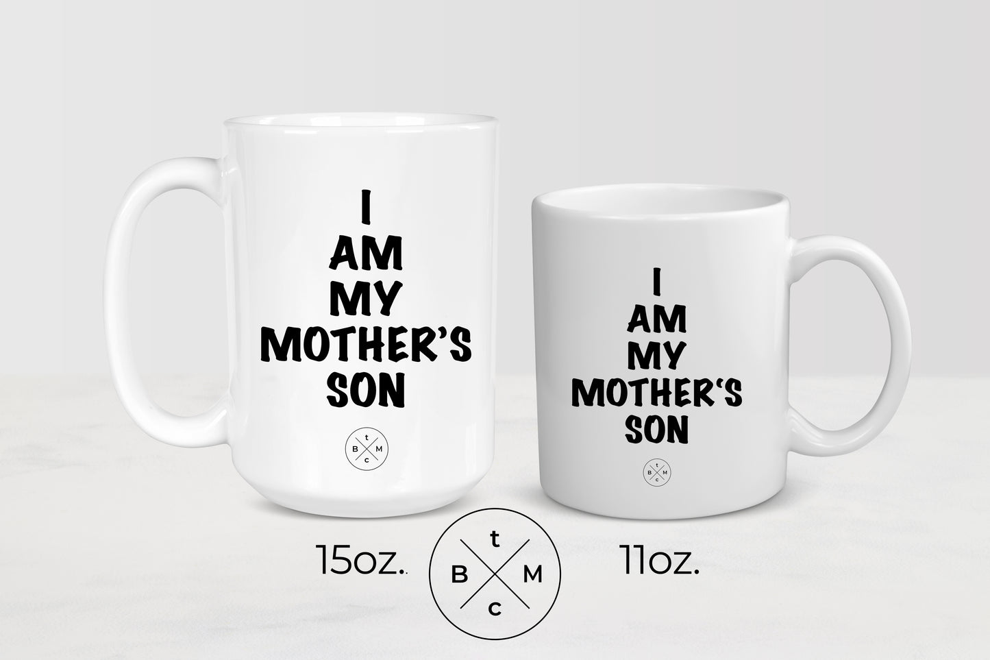 11ounce and 15 ounce white ceramic mugs with black text I am my mother’s son