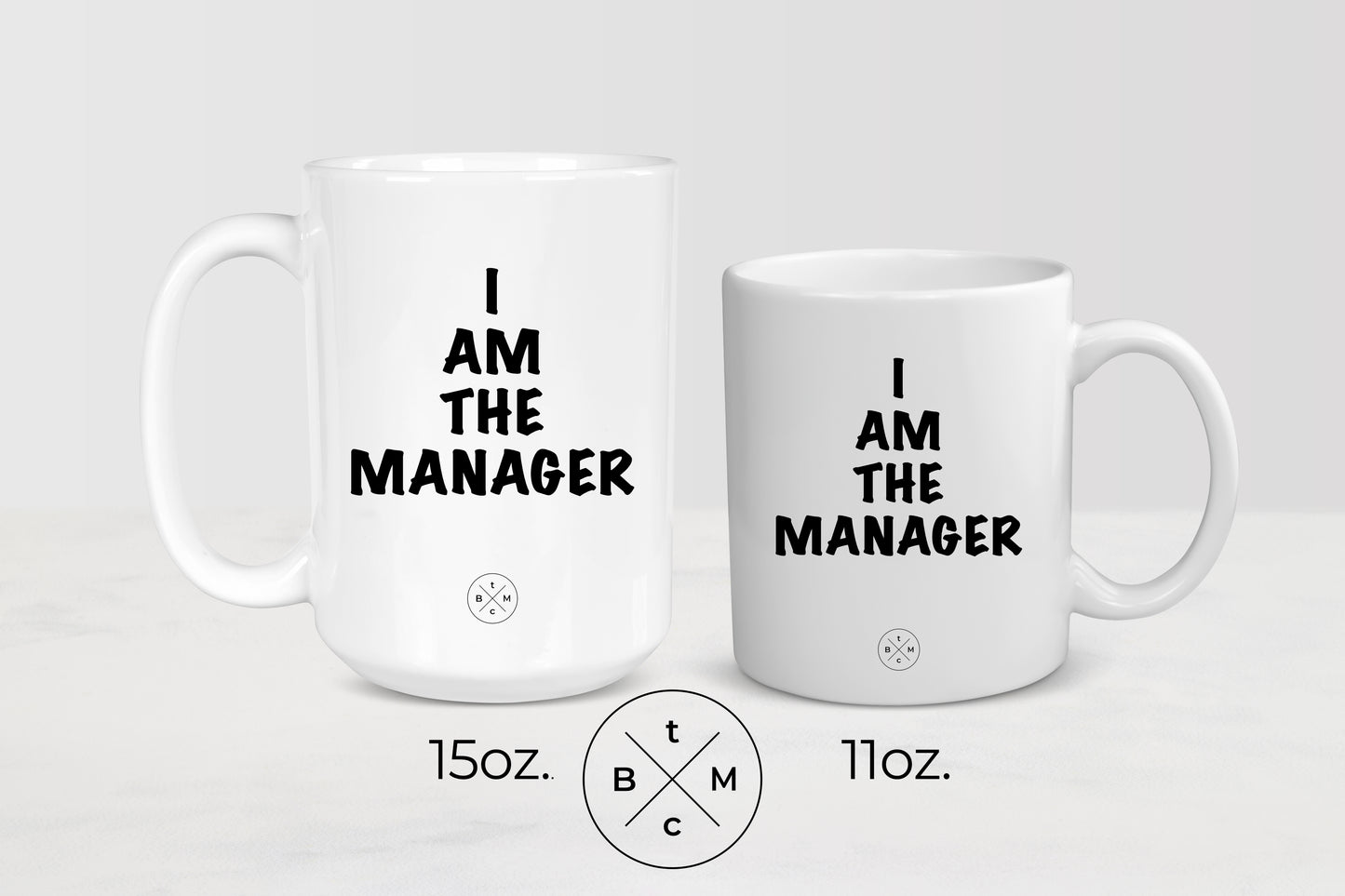 11 and 15 ounce white ceramic mugs with black text I am the manager