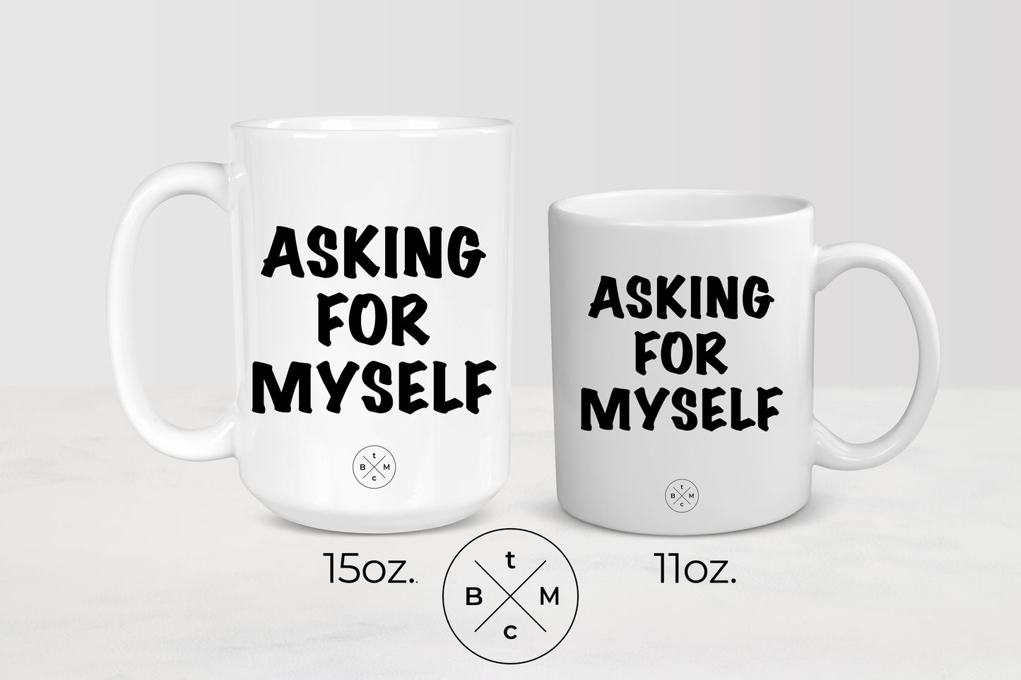 White 11 ounce and 15 ounce ceramic mugs with black text asking for myself