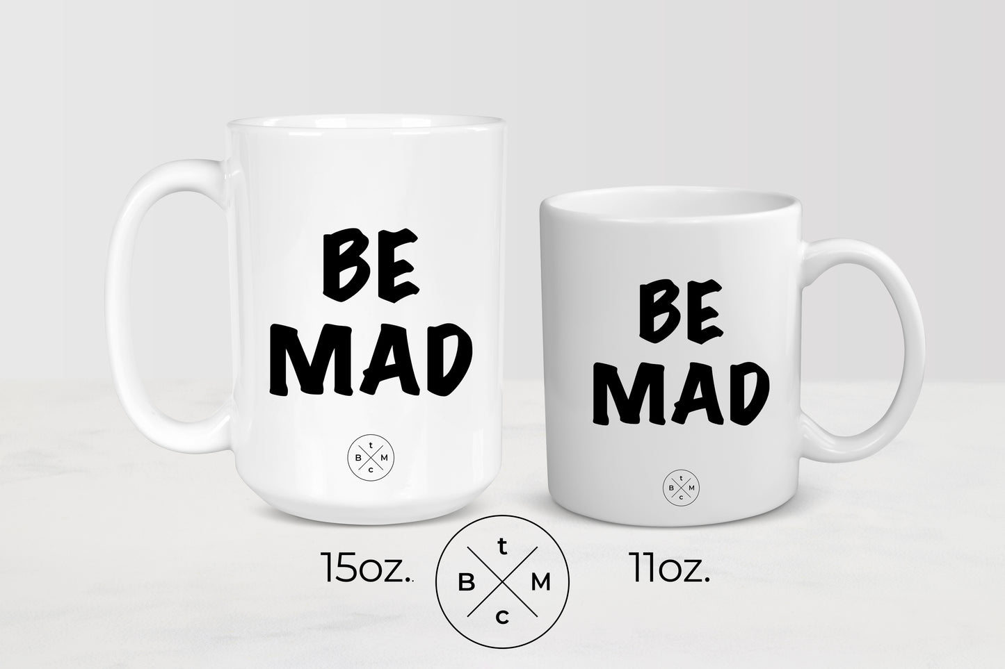 White 11 ounce and 15 ounce mug with black text be mad
