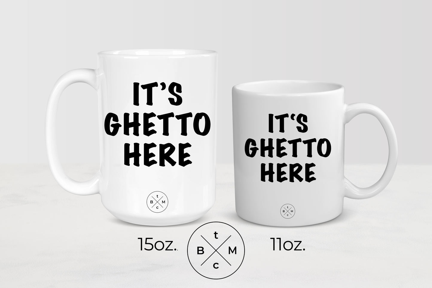 White 11 ounce and 15 ounce mugs with black text it’s ghetto here