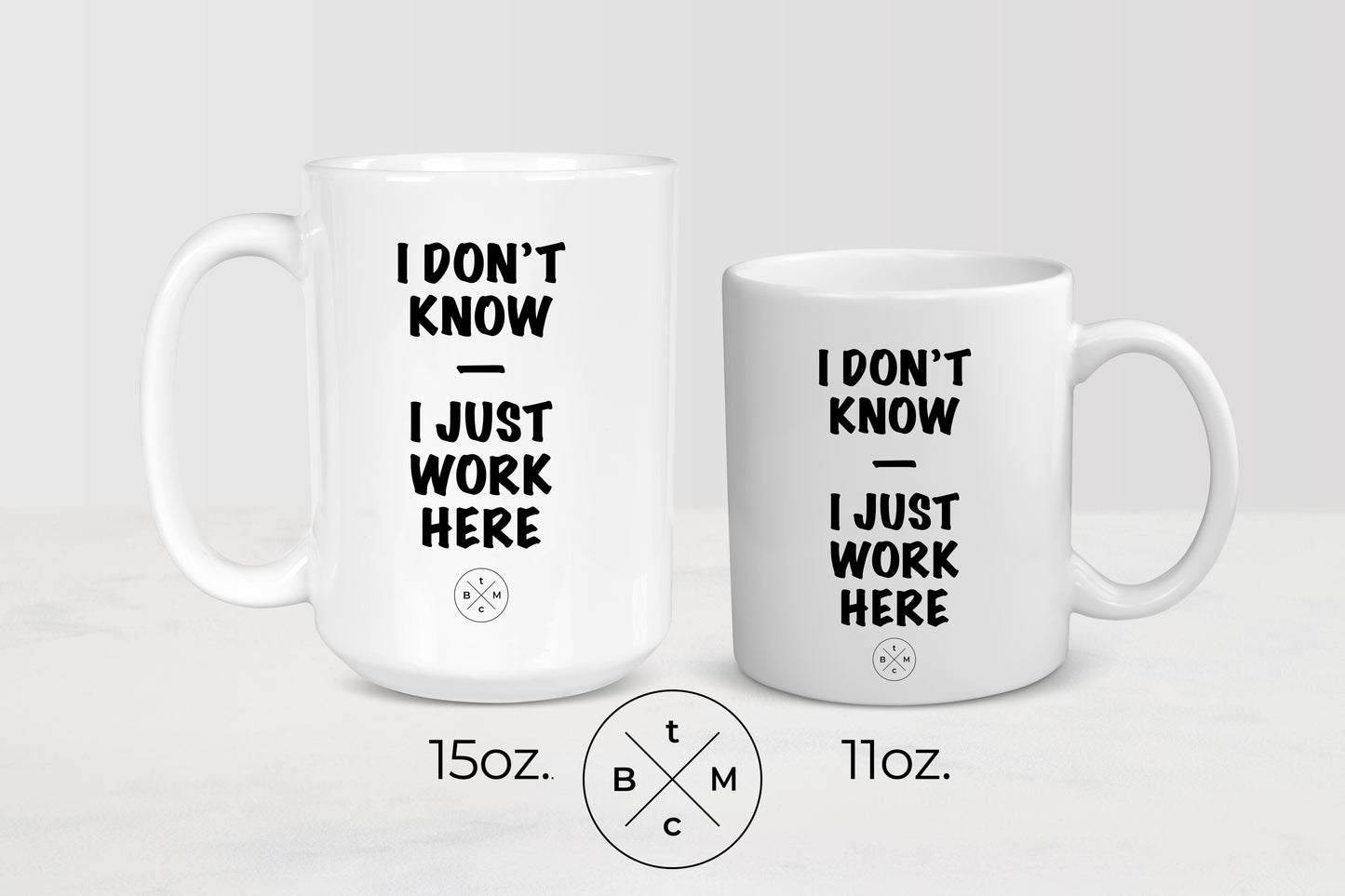 11 ounce and 15 ounce white ceramic mugs with black text I don’t know I just work here