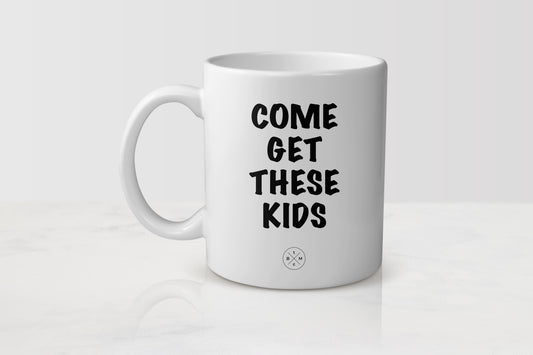 White ceramic mug with black text him get these kids