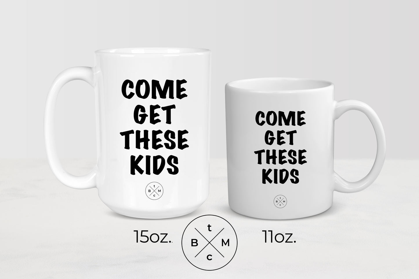 White ceramic mug with black text him get these kids