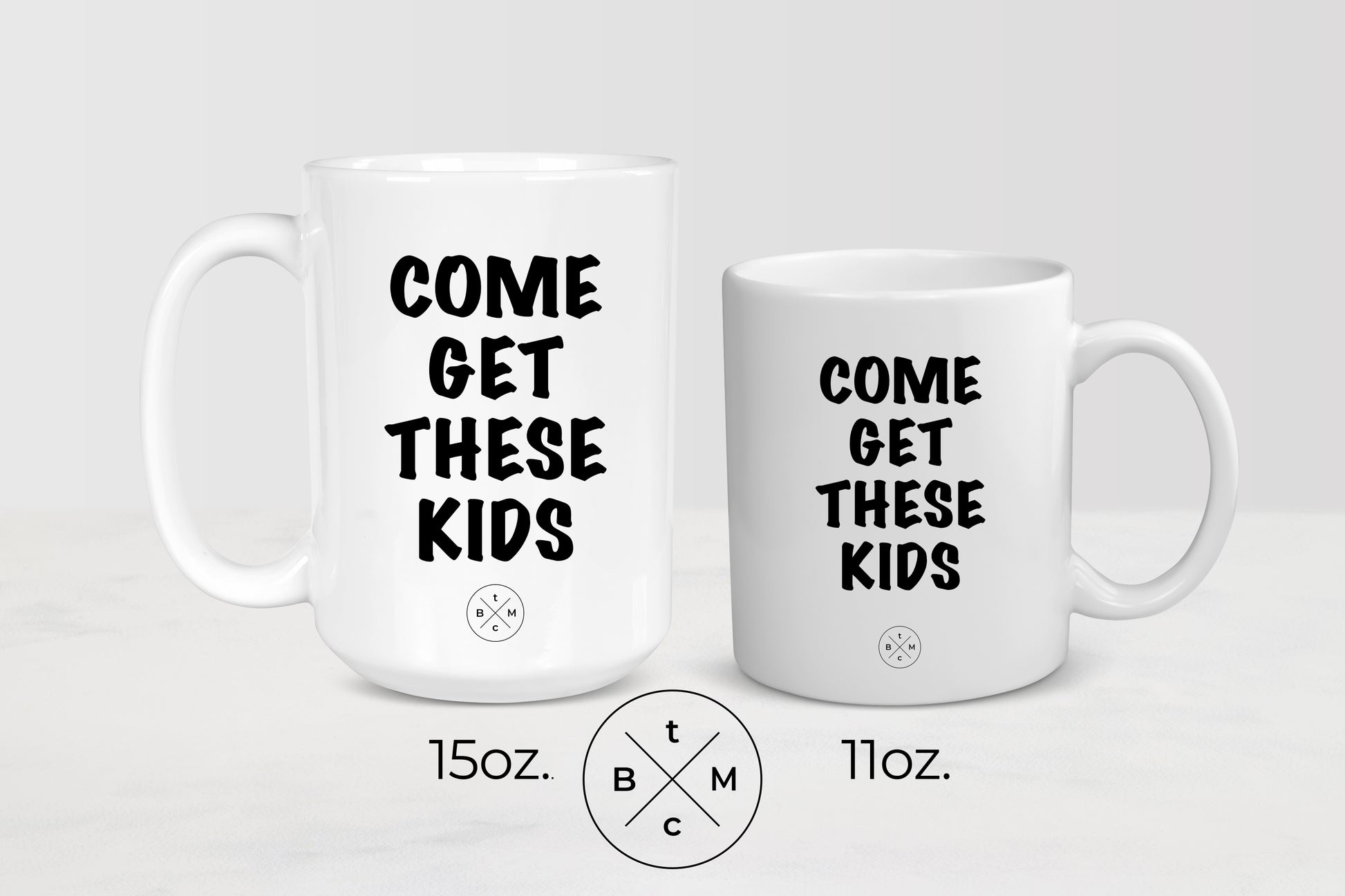 White ceramic mug with black text him get these kids