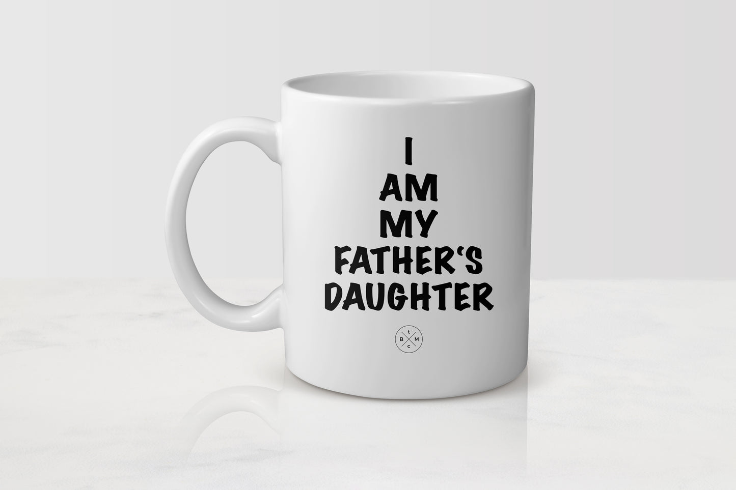 White 11 ounce ceramic mug with black text I am my father’s daughter