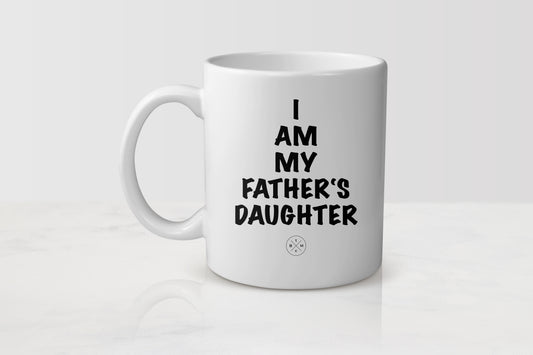White 11 ounce ceramic mug with black text I am my father’s daughter