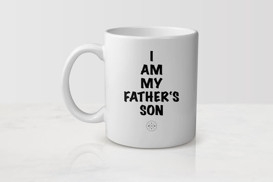 11 ounce white ceramic mug with black text I am my father’s son