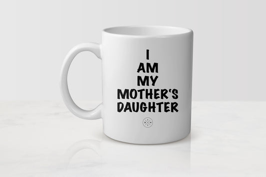 White 11 ounce ceramic mug with black text I am my mother’s daughter