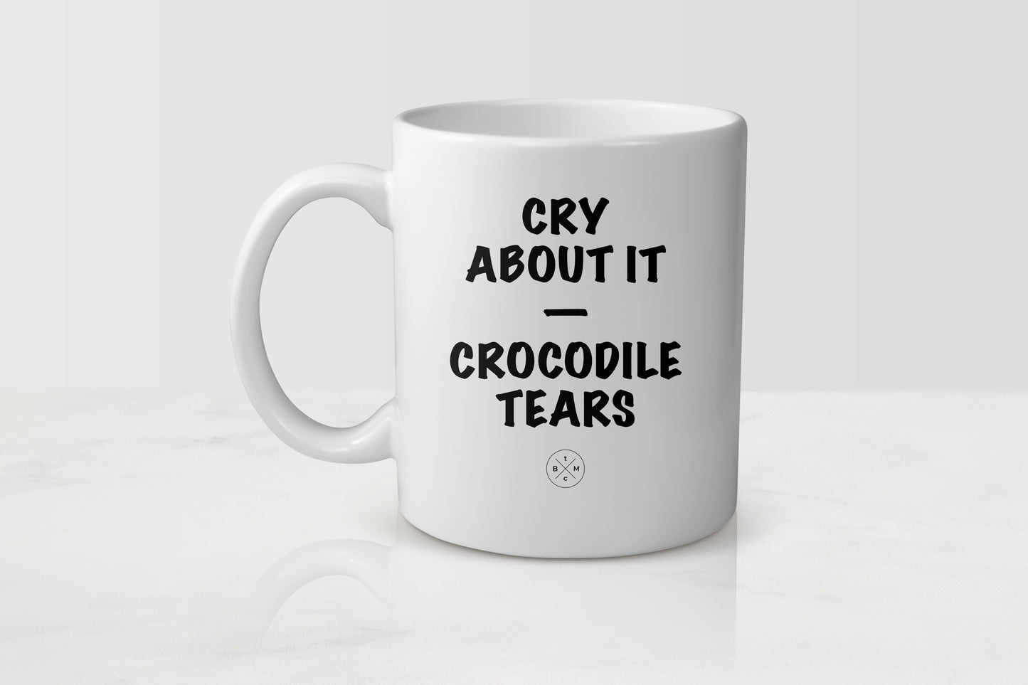 White 11 ounce ceramic mug with black text cry about it crocodile tears