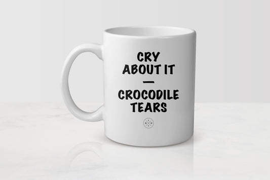White 11 ounce ceramic mug with black text cry about it crocodile tears