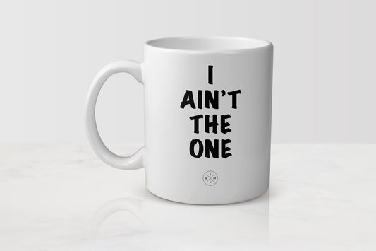 11 ounce white ceramic mug with black text I ain’t the one