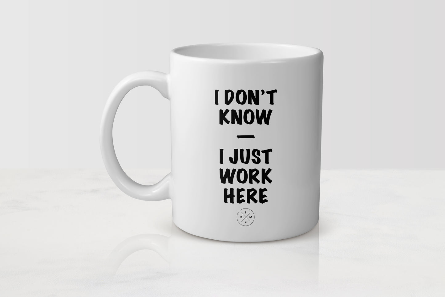 11 ounce white ceramic mug with black text I don’t know I just work here