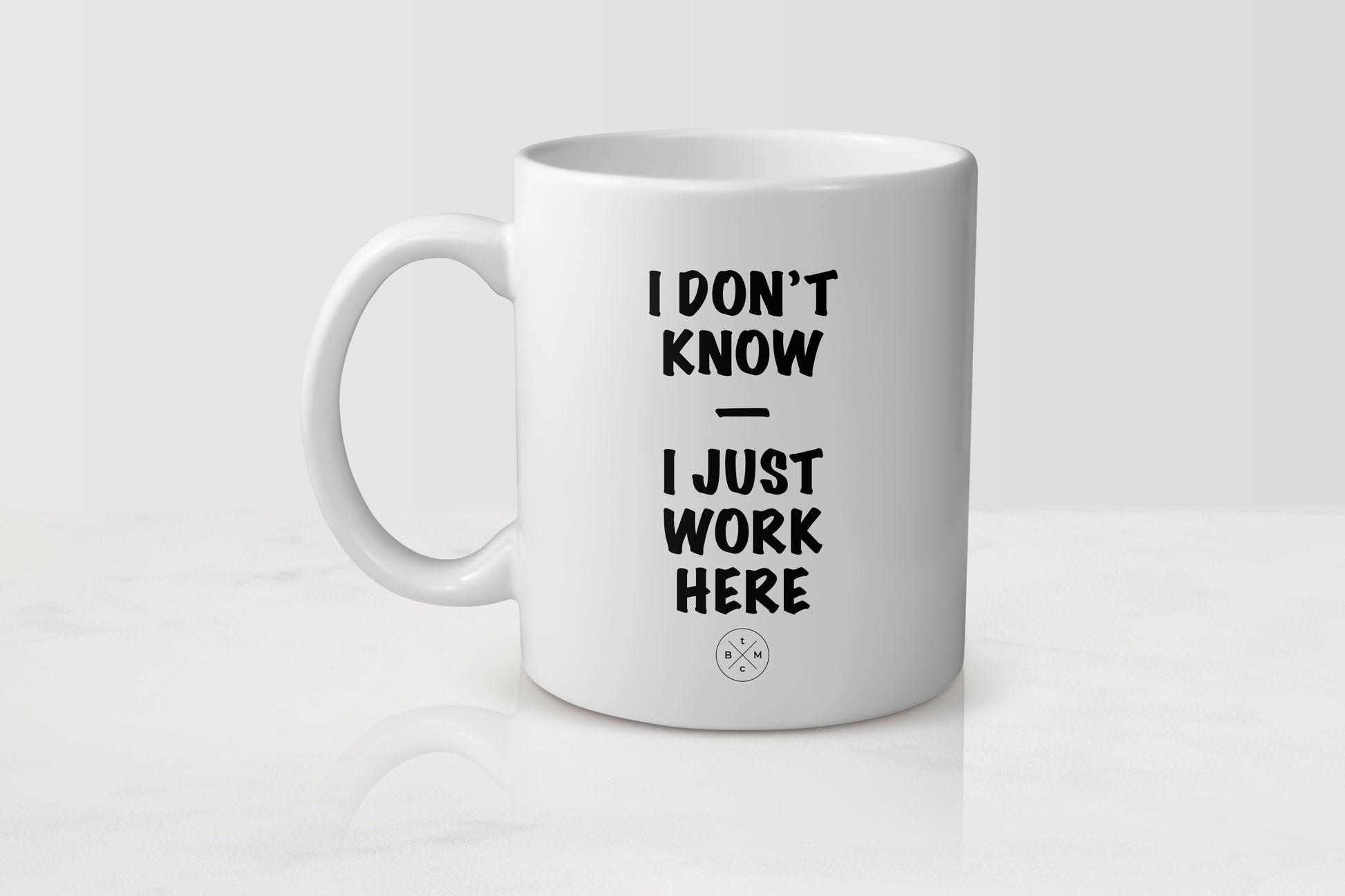 11 ounce white ceramic mug with black text I don’t know I just work here