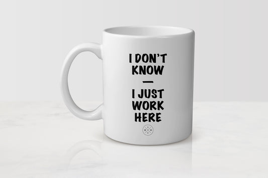 11 ounce white ceramic mug with black text I don’t know I just work here