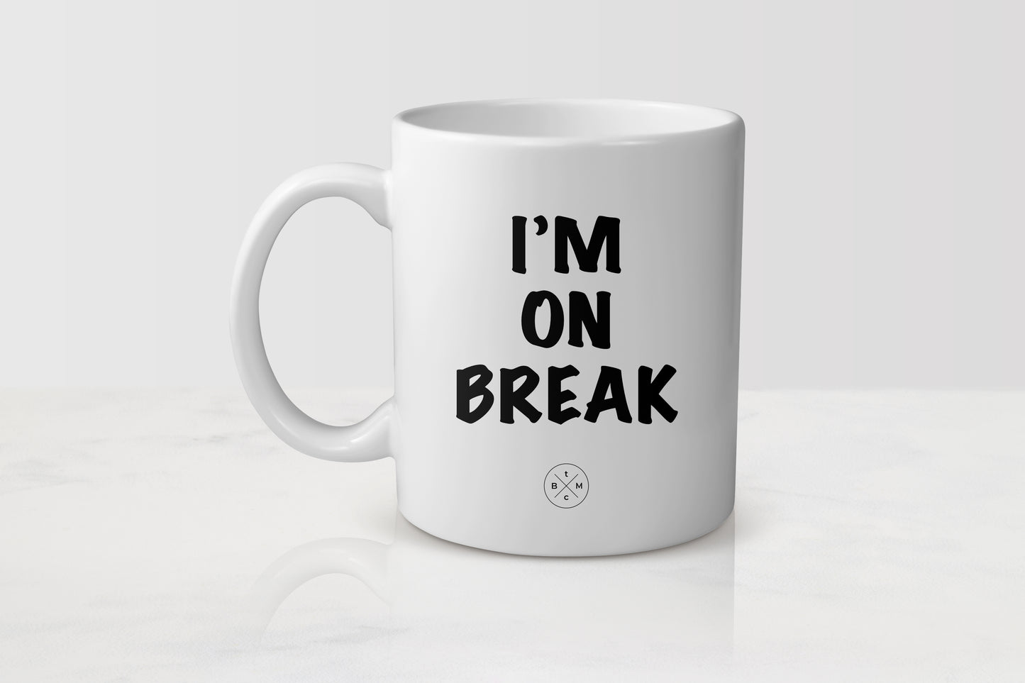 11 ounce white ceramic mug with black text I’m on break