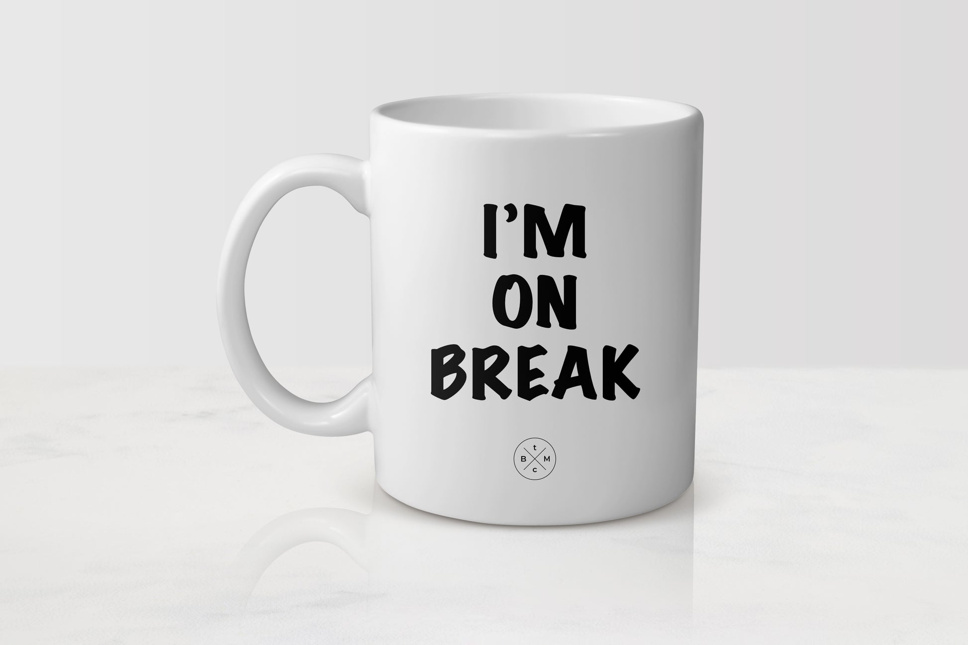 11 ounce white ceramic mug with black text I’m on break