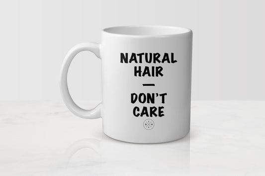 White 11 ounce ceramic mug with black text natural hair don’t care