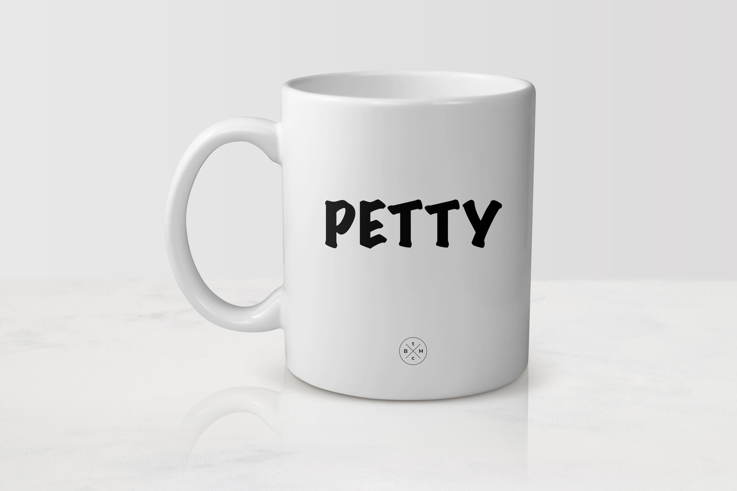 White 11 ounce ceramic mug with black text petty