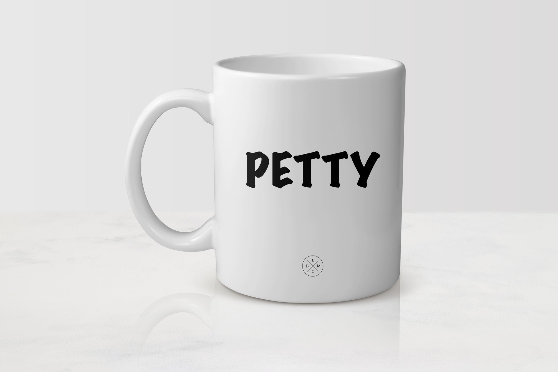 White 11 ounce ceramic mug with black text petty