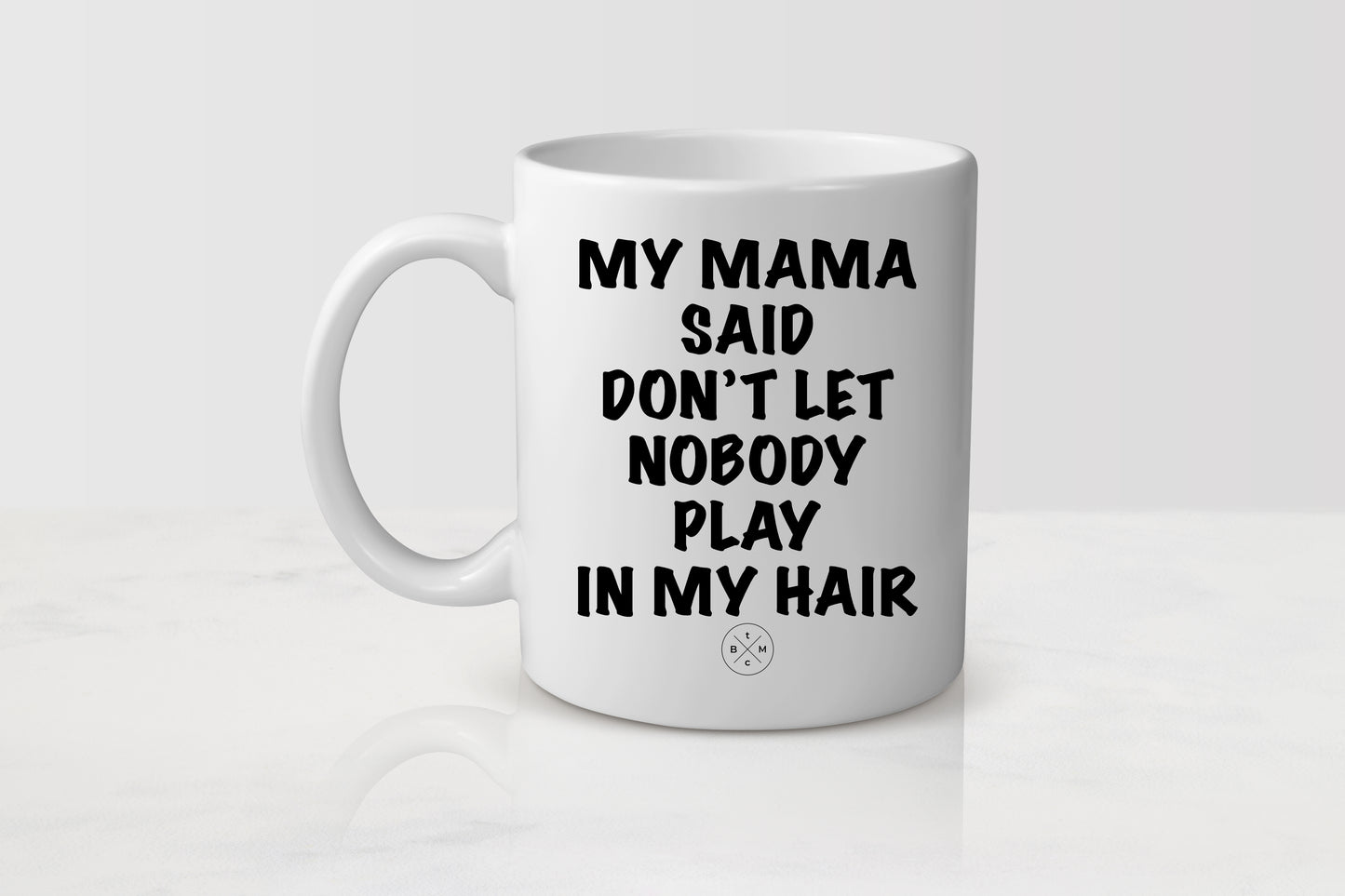 11 ounce white ceramic mug with black text my mama said don’t let nobody playing my hair