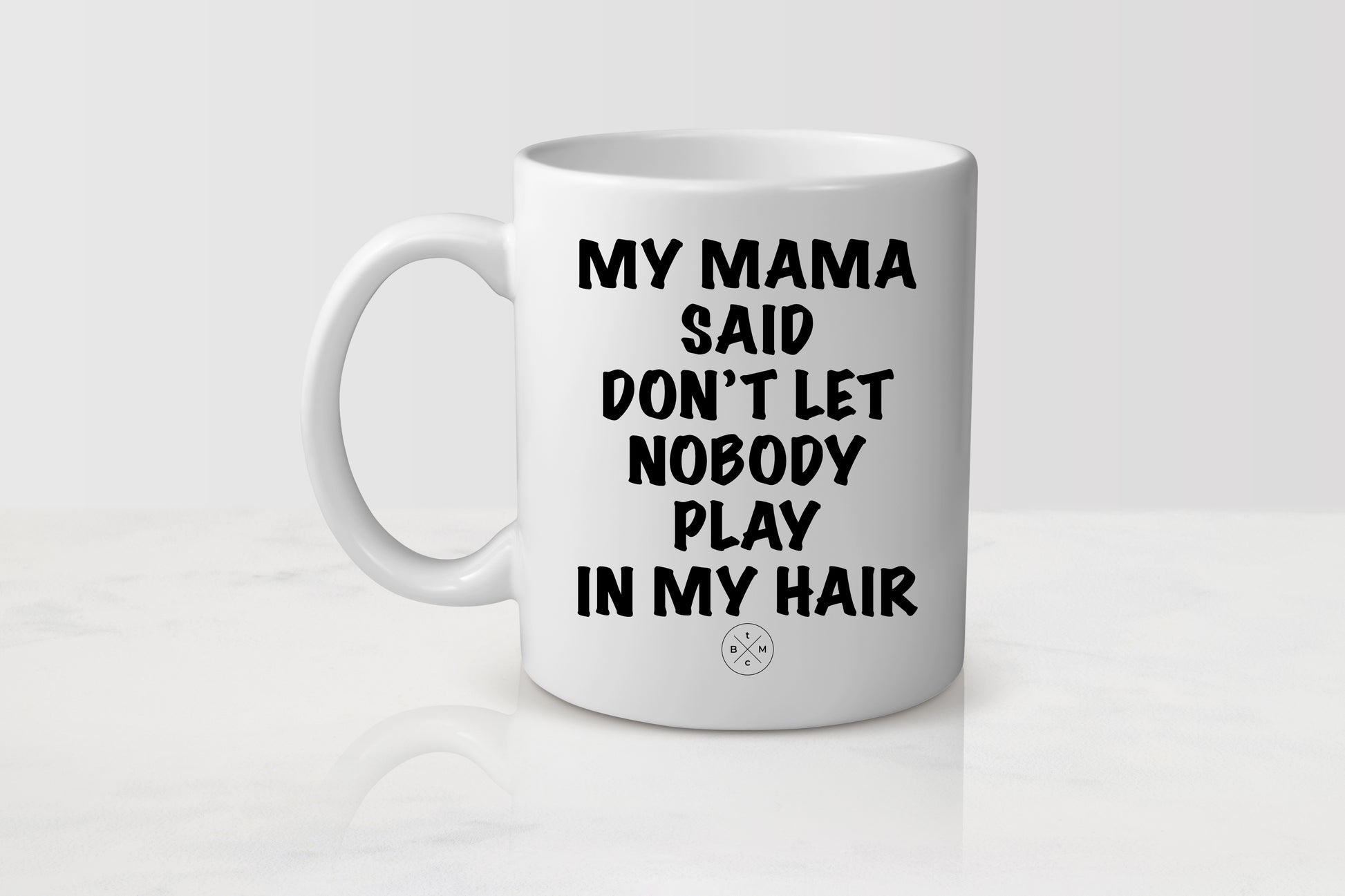 11 ounce white ceramic mug with black text my mama said don’t let nobody playing my hair