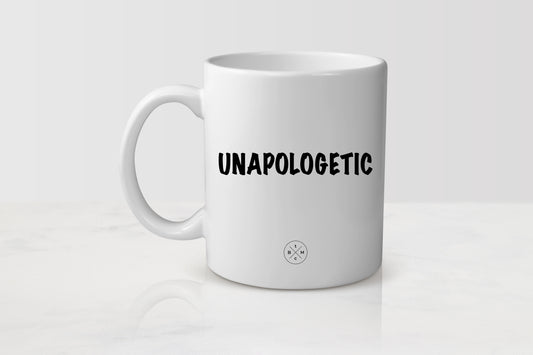 11 ounce white ceramic mug with black  text unapologetic