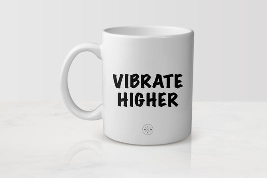 White 11 ounce ceramic mug with black text vibrate higher