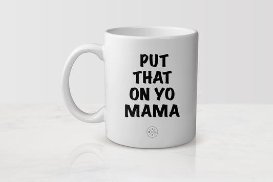 White 11 ounce mug with black text put that on yo mama