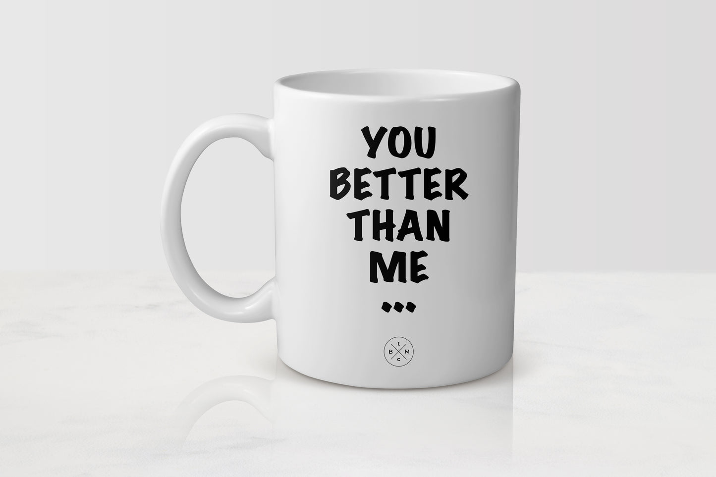 White 11 ounce ceramic mug with black text you better than me