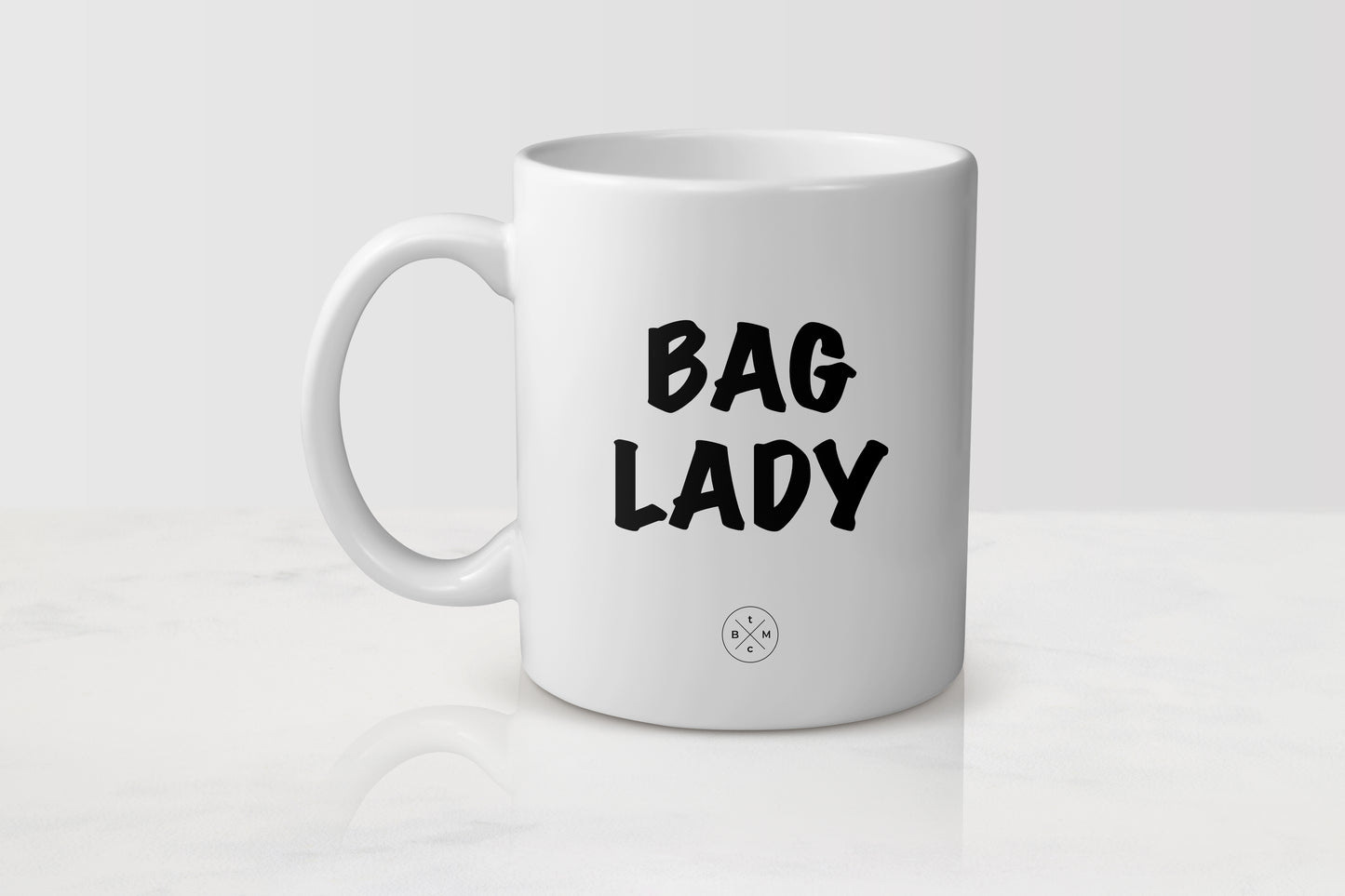 11 ounce white ceramic mug with black text bag lady