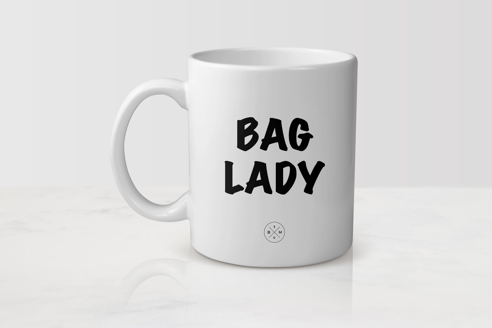 11 ounce white ceramic mug with black text bag lady