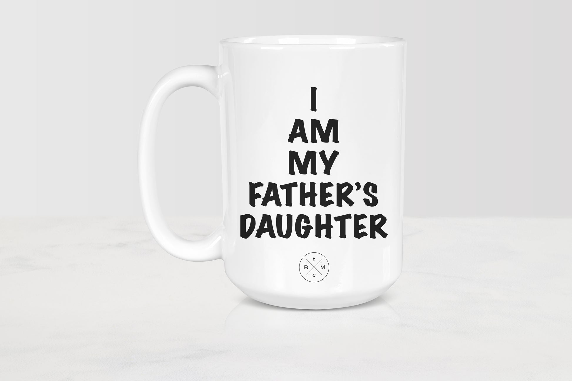 White 15 ounce ceramic mug with black text I am my father’s daughter