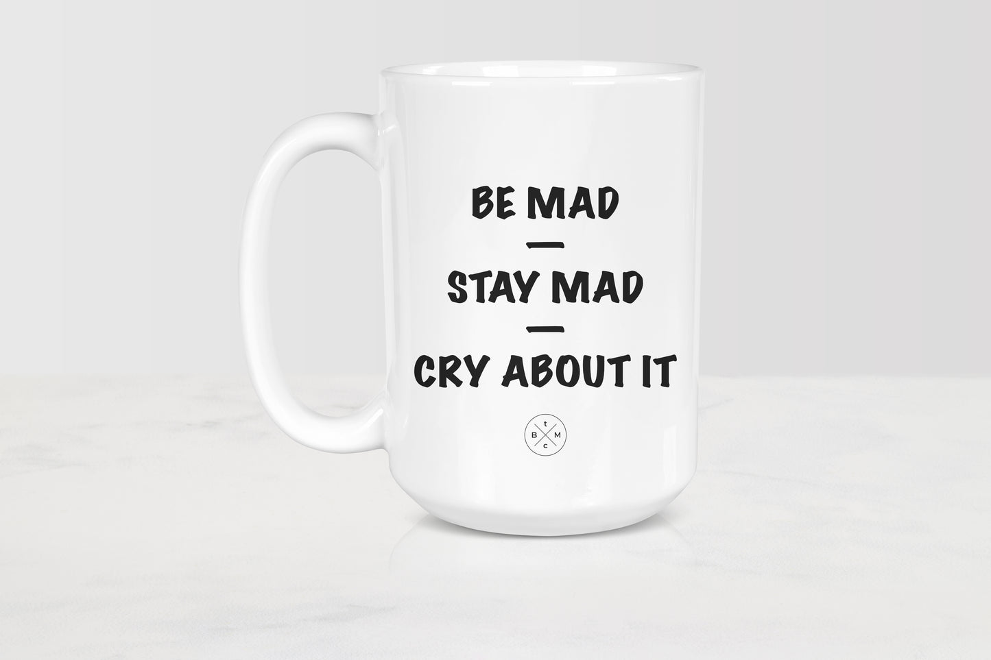 White 15 ounce ceramic mug with black text be mad stay mad cry about it