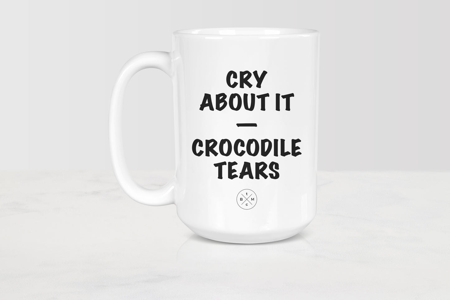 White 15 ounce ceramic mug with black text cry about it crocodile tears