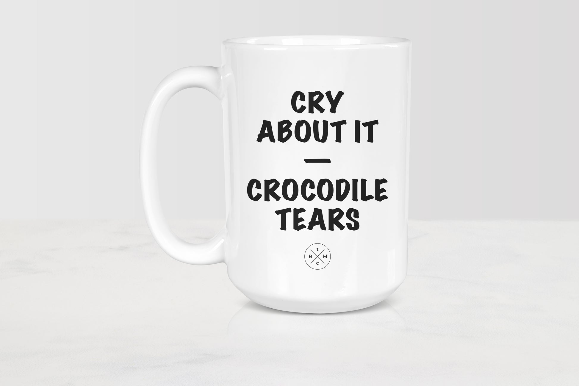 White 15 ounce ceramic mug with black text cry about it crocodile tears