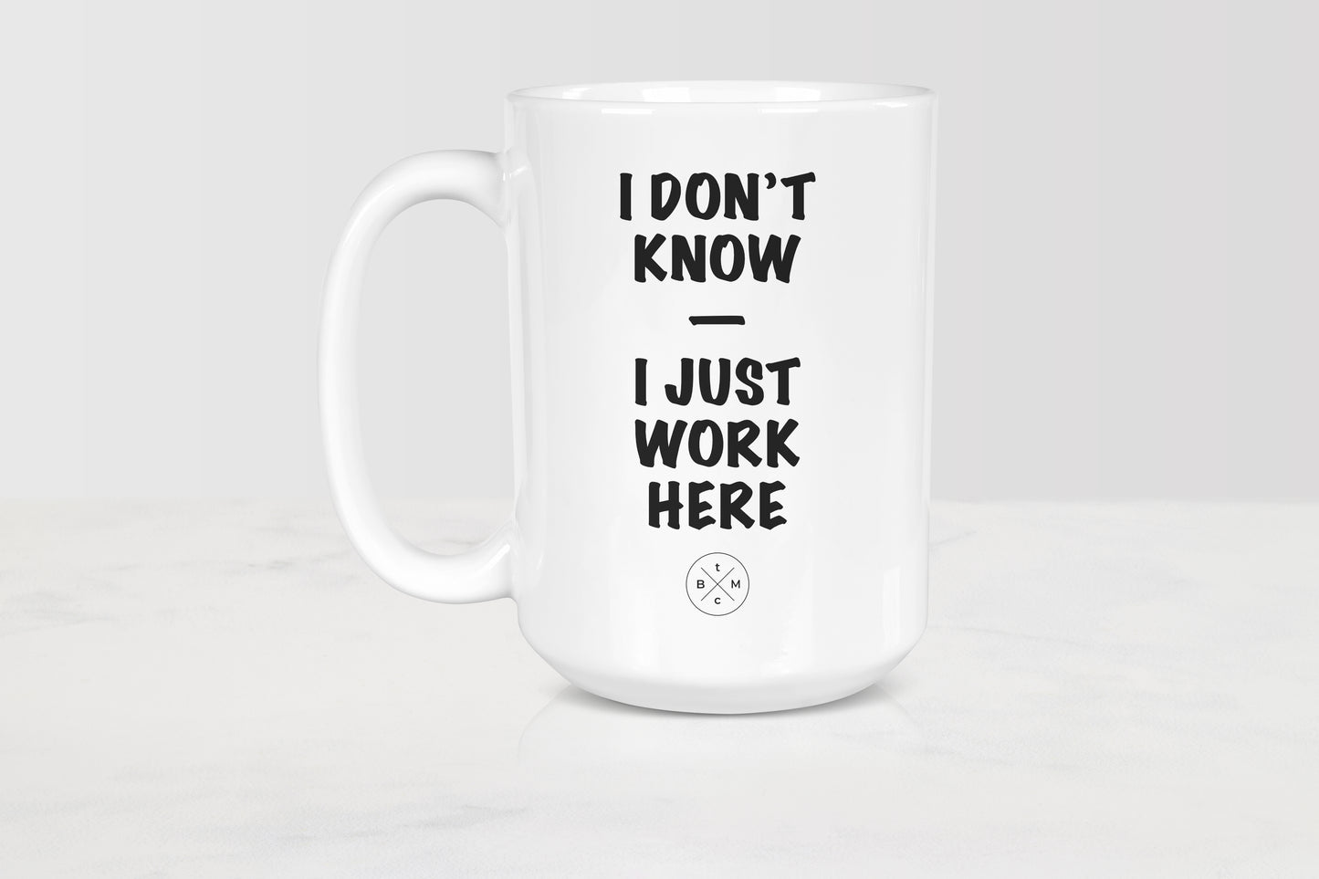 15 ounce white ceramic mug with black text I don’t know I just work here