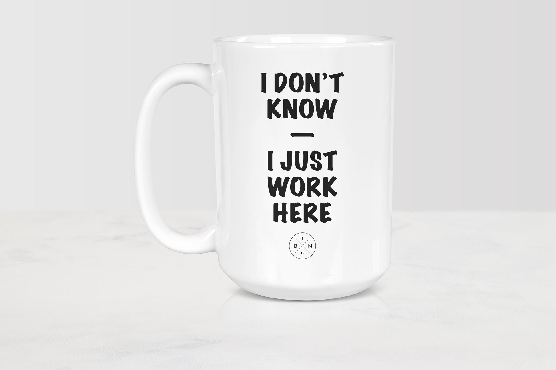 15 ounce white ceramic mug with black text I don’t know I just work here