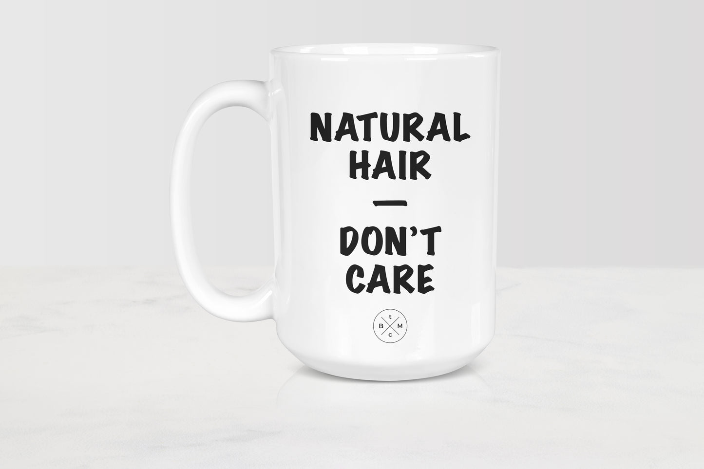White 15 ounce ceramic mug with black text natural hair don’t care