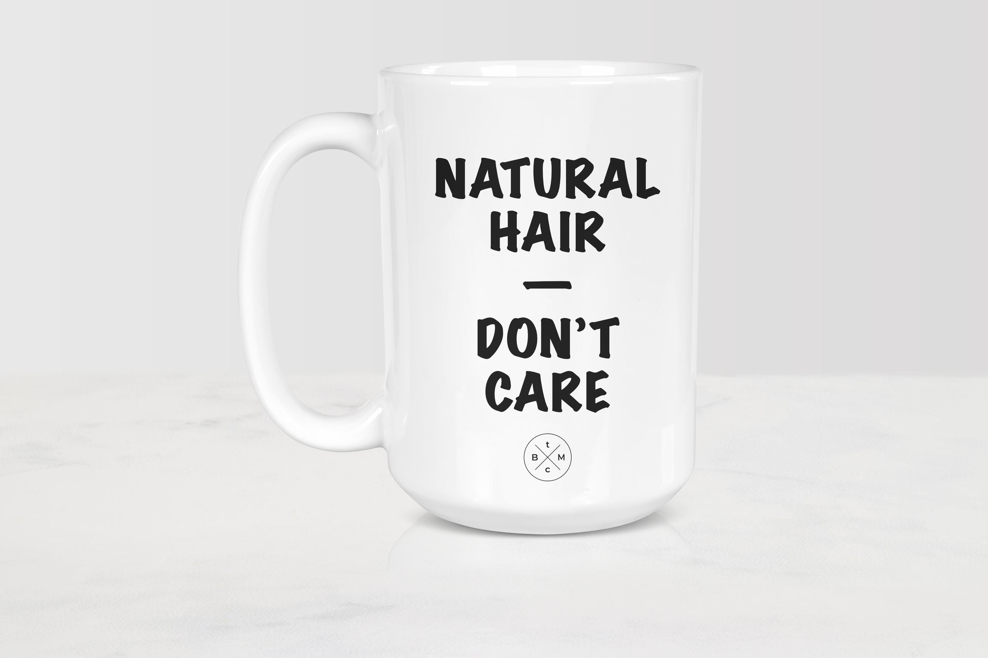 White 15 ounce ceramic mug with black text natural hair don’t care