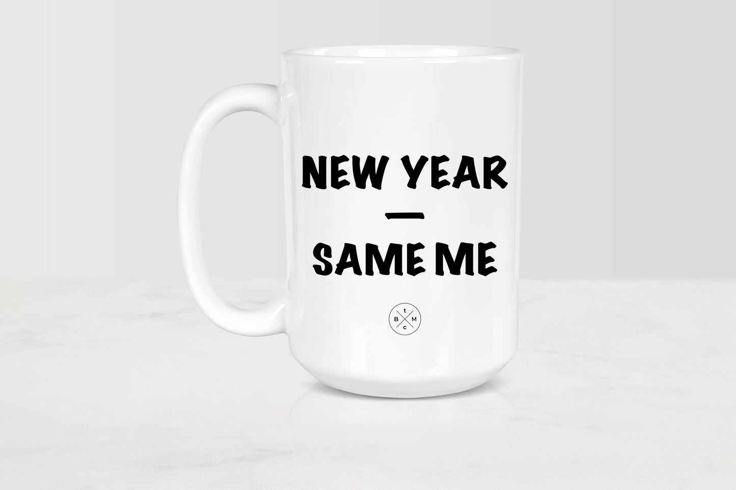 White 15 ounce ceramic mug with black text new year same me