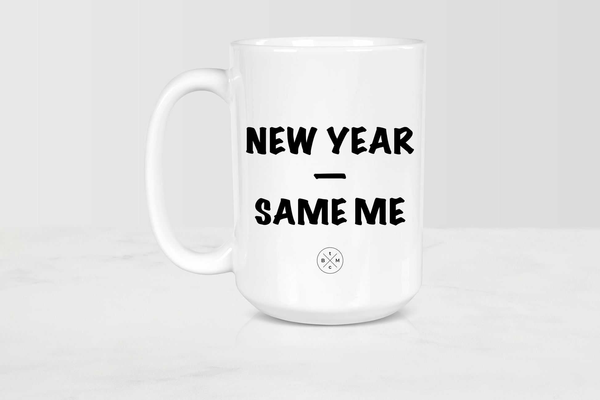 White 15 ounce ceramic mug with black text new year same me