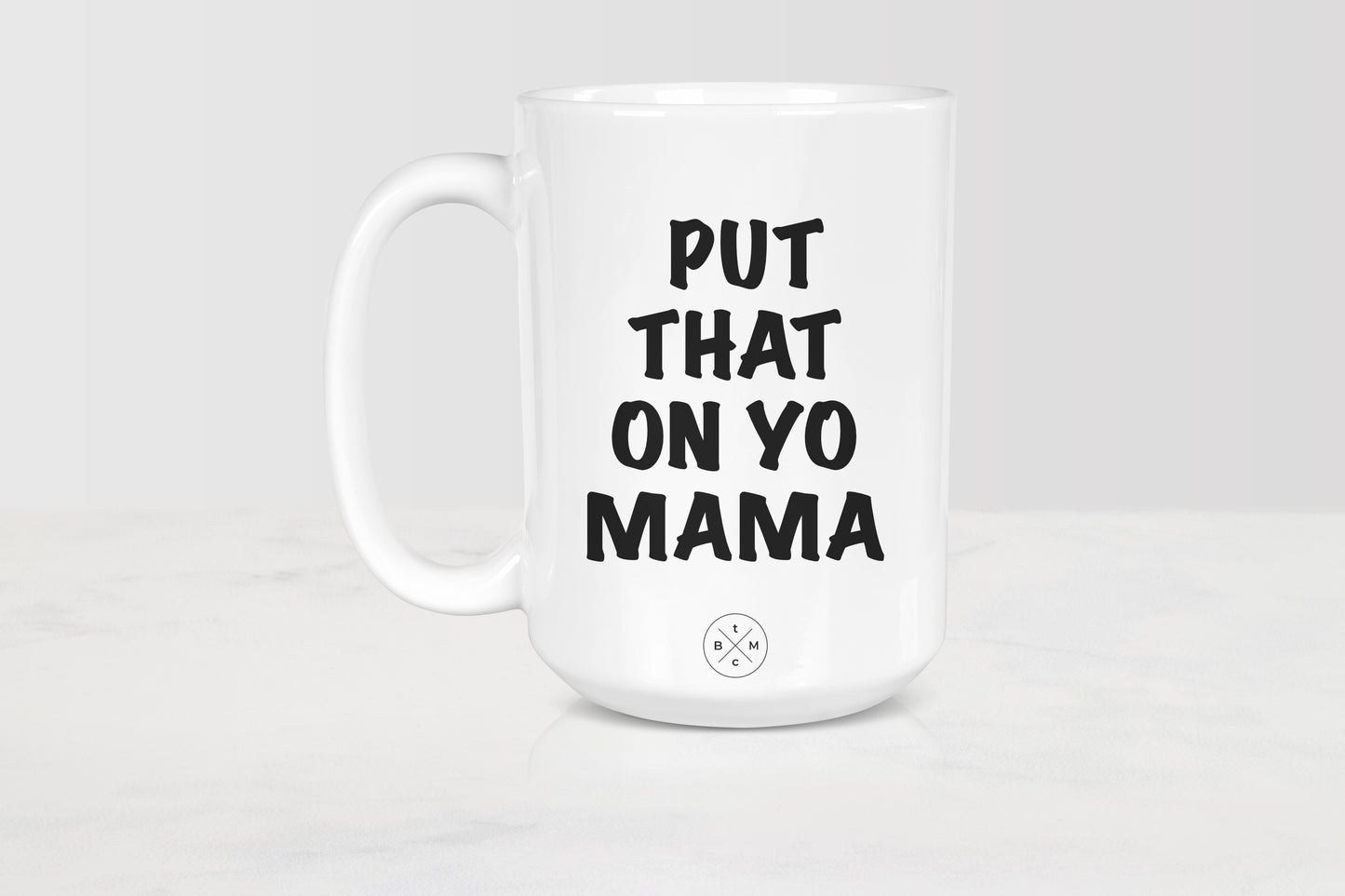 White 15 ounce mug with black text put that on yo mama