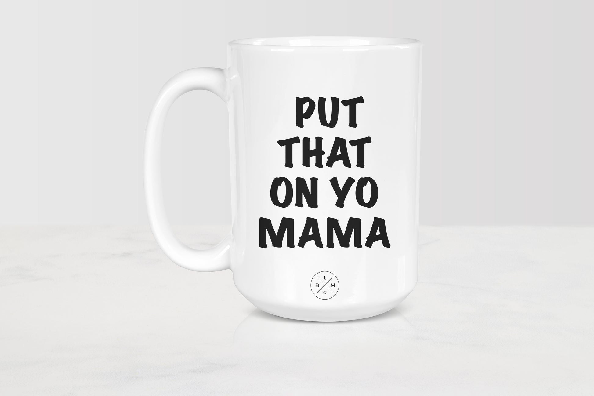 White 15 ounce mug with black text put that on yo mama