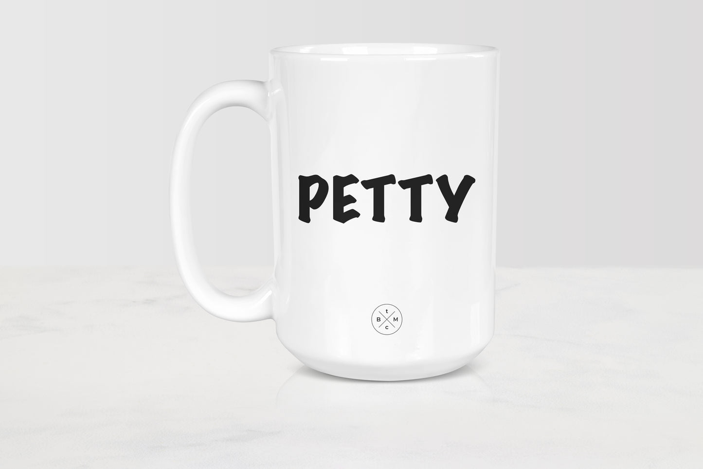 White 15 ounce ceramic mug with black text petty