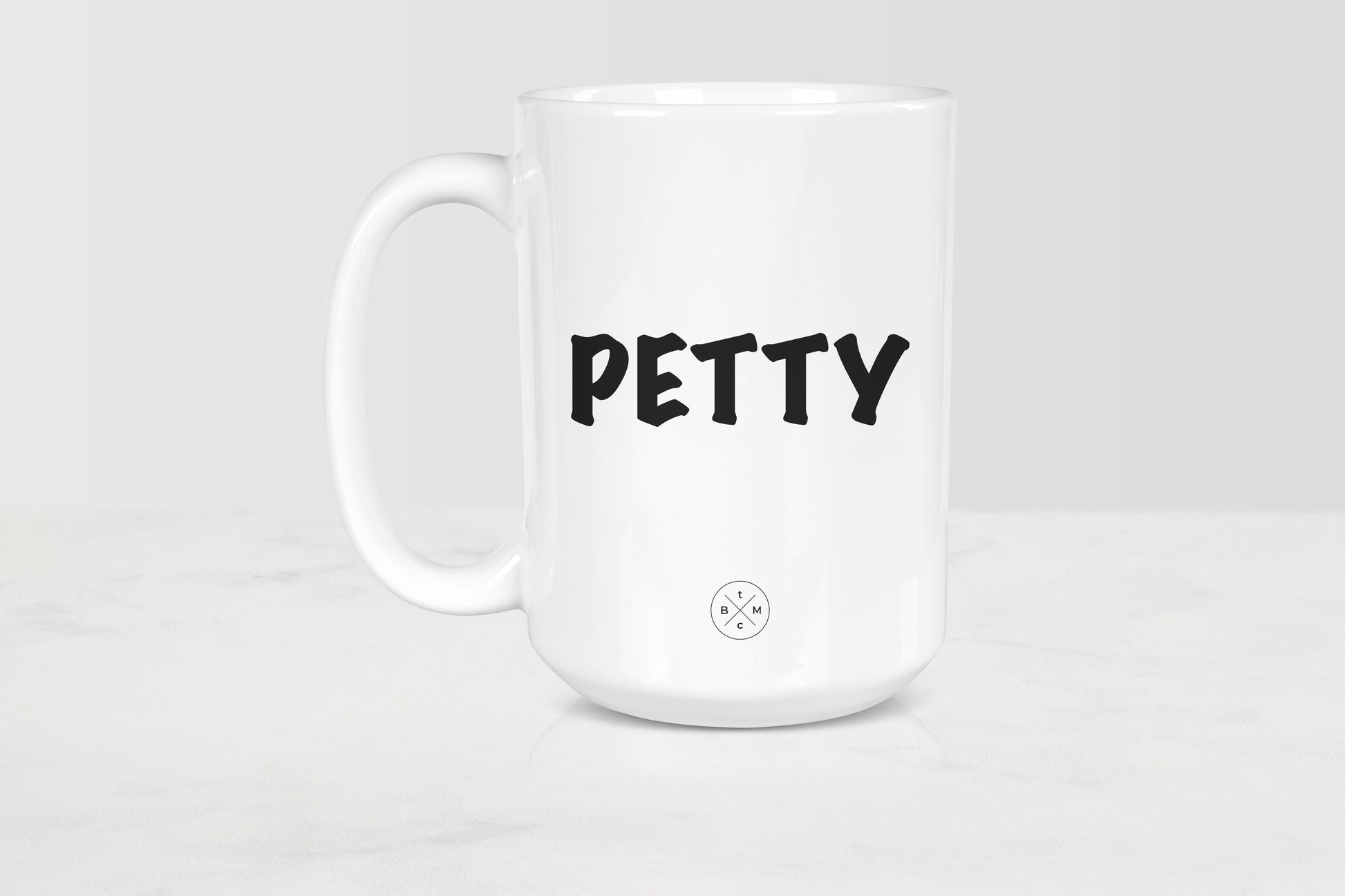 White 15 ounce ceramic mug with black text petty