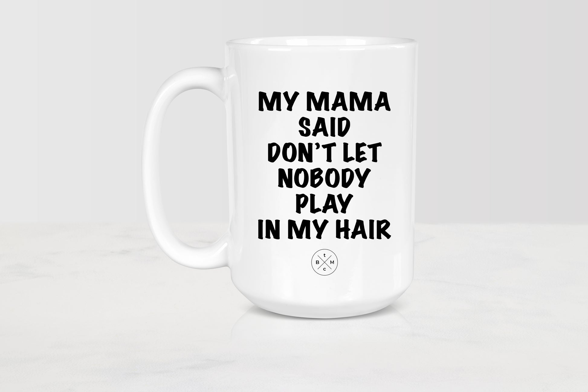 15 ounce white ceramic mug with black text my mama said don’t let nobody playing my hair
