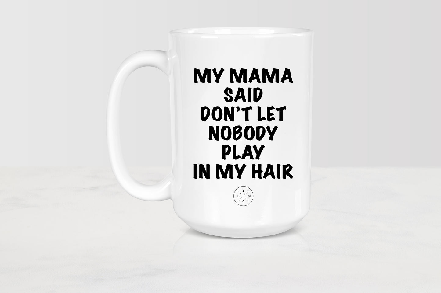 15 ounce white ceramic mug with black text my mama said don’t let nobody playing my hair