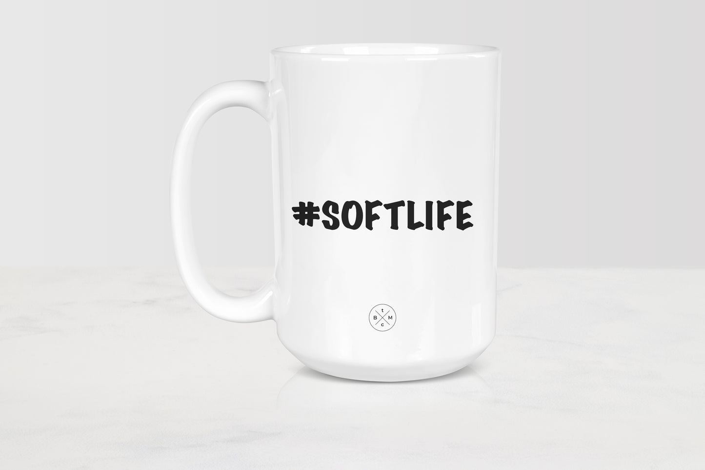 White 15 ounce ceramic mug with black text #SoftLife